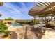 Inviting pool with outdoor kitchen, pergola, and mountain views at 15313 S 180Th Ave, Goodyear, AZ 85338