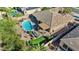 A large, private backyard with a covered patio, pool, putting green, desert landscaping, and seating area at 15442 W Sells Dr, Goodyear, AZ 85395