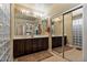 Bright bathroom features a double sink vanity, mirrors, and decorative hardware at 15442 W Sells Dr, Goodyear, AZ 85395