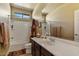 Bright bathroom with a shower-tub combo, toilet, and sink with contemporary design elements at 15442 W Sells Dr, Goodyear, AZ 85395