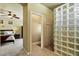 Bathroom offering tiled floor, a shower with glass block, and entry to the bedroom at 15442 W Sells Dr, Goodyear, AZ 85395