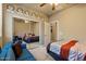 Spacious bedroom with world clocks, mirrored closet and a blue sofa perfect for relaxing at 15442 W Sells Dr, Goodyear, AZ 85395