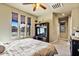 Bright bedroom showcasing large windows, soft lighting, and a ceiling fan at 15442 W Sells Dr, Goodyear, AZ 85395