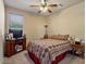Cozy bedroom with a ceiling fan, TV on cabinet and comfortable bed for relaxing at 15442 W Sells Dr, Goodyear, AZ 85395