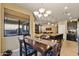 A formal dining area featuring modern chandelier lighting and views of the backyard at 15442 W Sells Dr, Goodyear, AZ 85395