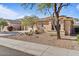 Well-maintained single-story home with low-maintenance desert landscaping and neutral exterior paint at 15442 W Sells Dr, Goodyear, AZ 85395