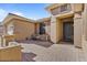 Inviting front porch with a seating area, enhanced by stone accents and a stylish entrance door at 15442 W Sells Dr, Goodyear, AZ 85395