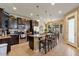 Bright kitchen with granite countertops, stainless steel appliances, and dark wood cabinets at 15442 W Sells Dr, Goodyear, AZ 85395