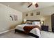 Bedroom features soft neutral walls, a ceiling fan and views from the decorative windows at 15442 W Sells Dr, Goodyear, AZ 85395