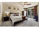 Bedroom with a ceiling fan, French doors to the backyard, and neutral-toned walls and floors at 15442 W Sells Dr, Goodyear, AZ 85395