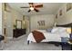 Well-lit bedroom featuring soft lighting, a ceiling fan, and convenient access to the ensuite bathroom at 15442 W Sells Dr, Goodyear, AZ 85395