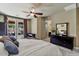 Comfortable bedroom showcasing neutral walls, ceiling fan and private backyard patio access at 15442 W Sells Dr, Goodyear, AZ 85395