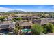 An aerial view showing a neighborhood surrounded by desert, green spaces, and mountain views at 15442 W Sells Dr, Goodyear, AZ 85395