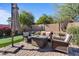 Outdoor seating area with comfortable seating and a gas fireplace for relaxing outdoors at 15442 W Sells Dr, Goodyear, AZ 85395