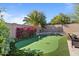 Landscaped putting green area bordered by desert plants and a brick wall at 15442 W Sells Dr, Goodyear, AZ 85395