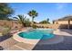 Desert landscaped pool with rock feature and desert landscaping, with a sun deck at 15442 W Sells Dr, Goodyear, AZ 85395