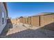 View of the fenced backyard with desert landscaping at 15564 W Williams St, Goodyear, AZ 85338