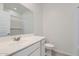 Bathroom with a single sink vanity, a toilet, and a shower reflected in the mirror at 15564 W Williams St, Goodyear, AZ 85338