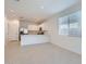 Spacious open-concept kitchen with stainless steel appliances, white cabinets, and breakfast bar at 15564 W Williams St, Goodyear, AZ 85338