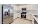 Modern kitchen features stainless steel appliances, white cabinets, and quartz countertops at 15564 W Williams St, Goodyear, AZ 85338