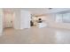 Bright, open-concept living room with tile floors connecting to a modern kitchen with stainless steel appliances at 15564 W Williams St, Goodyear, AZ 85338