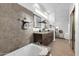 A bright bathroom with double sinks, granite countertops, a soaking tub, and access to the main bedroom at 15865 E Lost Hills Dr, Fountain Hills, AZ 85268
