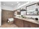 A stylish bathroom featuring double sinks, granite counters, wooden cabinets and tile flooring at 15865 E Lost Hills Dr, Fountain Hills, AZ 85268