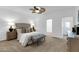 Spacious bedroom with soft carpet, ceiling fan, and a tufted headboard at 15865 E Lost Hills Dr, Fountain Hills, AZ 85268