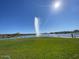 Scenic community lake view with a fountain and walking path on a sunny day at 15865 E Lost Hills Dr, Fountain Hills, AZ 85268