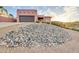 Southwestern home exterior boasts a desert rock front yard for low maintenance landscaping at 15865 E Lost Hills Dr, Fountain Hills, AZ 85268