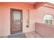 Close-up view of the home's front door and entryway with desert-style accents at 15865 E Lost Hills Dr, Fountain Hills, AZ 85268