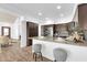 Eat-in kitchen with a granite countertop bar, stainless appliances, and dark wood cabinets, perfect for gatherings at 15865 E Lost Hills Dr, Fountain Hills, AZ 85268