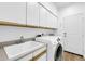 Well-organized laundry room featuring modern washer and dryer, plus ample cabinet space at 15865 E Lost Hills Dr, Fountain Hills, AZ 85268
