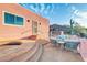 Charming outdoor space with a cozy seating area and steps leading down to a spa at 15865 E Lost Hills Dr, Fountain Hills, AZ 85268