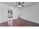 A view of the bedroom with hardwood floors and a view into the en suite bathroom and walk-in closet at 19777 N 76Th St # 2150, Scottsdale, AZ 85255