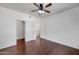 Hardwood floors in the bedroom, closet space, and an open door to the en suite bathroom at 19777 N 76Th St # 2150, Scottsdale, AZ 85255