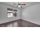 A clean, well-lit bedroom with hardwood floors and a large window for natural light at 19777 N 76Th St # 2150, Scottsdale, AZ 85255