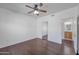The bedroom has hardwood floors, a ceiling fan, and a view of the en suite bathroom at 19777 N 76Th St # 2150, Scottsdale, AZ 85255