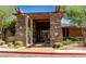 A grand stone clubhouse entrance with lush landscaping and a well-maintained walkway at 19777 N 76Th St # 2150, Scottsdale, AZ 85255