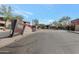 Gated community entrance with flowering bushes and well maintained landscaping at 19777 N 76Th St # 2150, Scottsdale, AZ 85255