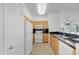 Bright kitchen features light wood cabinets, black countertops, and white appliances at 19777 N 76Th St # 2150, Scottsdale, AZ 85255