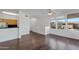 Open-concept living area with breakfast bar, hardwood floors, and large windows at 19777 N 76Th St # 2150, Scottsdale, AZ 85255