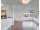 Open-concept living area with breakfast bar, hardwood floors, and large windows at 19777 N 76Th St # 2150, Scottsdale, AZ 85255
