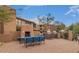 Community outdoor kitchen and fireplace with gas grills and blue cushioned seating at 19777 N 76Th St # 2150, Scottsdale, AZ 85255
