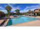 Refreshing community pool with lounge chairs and blue umbrellas for relaxation under the sun at 19777 N 76Th St # 2150, Scottsdale, AZ 85255