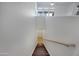 A bright staircase leads down to a lower level with a tiled floor and neutral walls at 19777 N 76Th St # 2150, Scottsdale, AZ 85255
