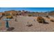 Expansive backyard with desert landscaping and privacy walls at 1994 E Dust Devil Dr, San Tan Valley, AZ 85143