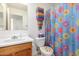 Bathroom with vanity, toilet, and a shower/tub combo with a colorful shower curtain at 1994 E Dust Devil Dr, San Tan Valley, AZ 85143
