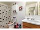 Functional bathroom featuring a toilet, vanity with sink, and a shower/tub with shower curtain at 1994 E Dust Devil Dr, San Tan Valley, AZ 85143