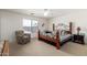 Bright bedroom showcasing a wood frame bed, large window and ceiling fan for comfortable living at 1994 E Dust Devil Dr, San Tan Valley, AZ 85143
